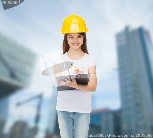 Image of smiling little girl in hardhat with clipboard