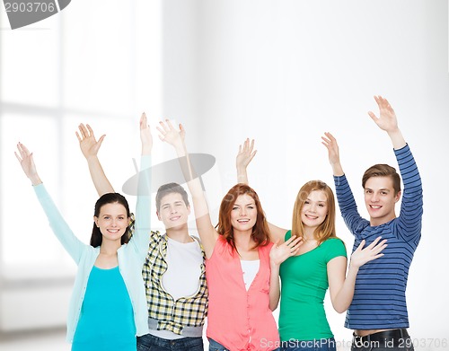 Image of group of smiling students waving hands