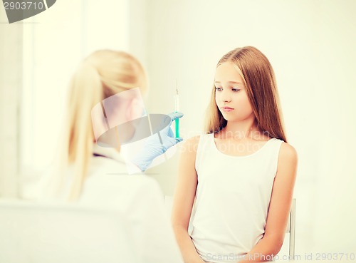 Image of doctor doing vaccine to child in hospital