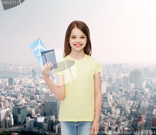 Image of smiling little girl with ticket and passport