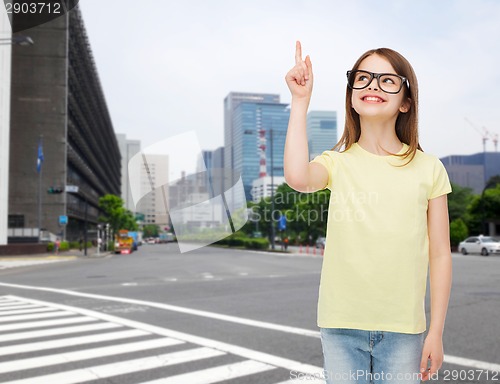 Image of smiling cute little girl in black eyeglasses