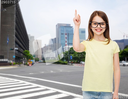 Image of smiling cute little girl in black eyeglasses