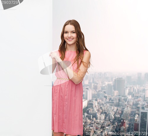 Image of young woman in dress with white blank board