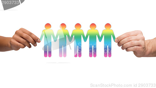 Image of hands holding paper chain gay people