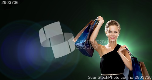 Image of smiling woman in dress with shopping bags