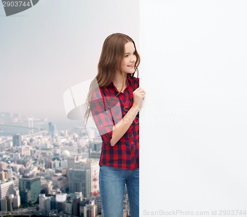 Image of smiling young teenage girl with white blank board