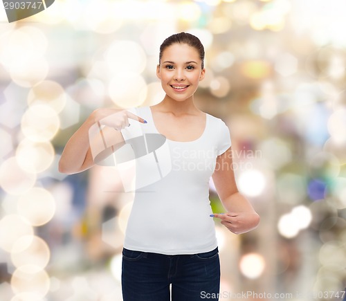 Image of smiling young woman in blank white t-shirt