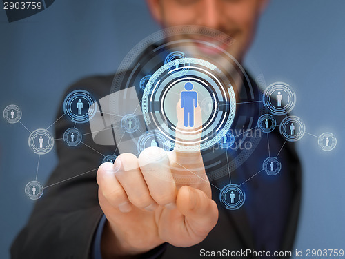 Image of businessman pressing button with contact