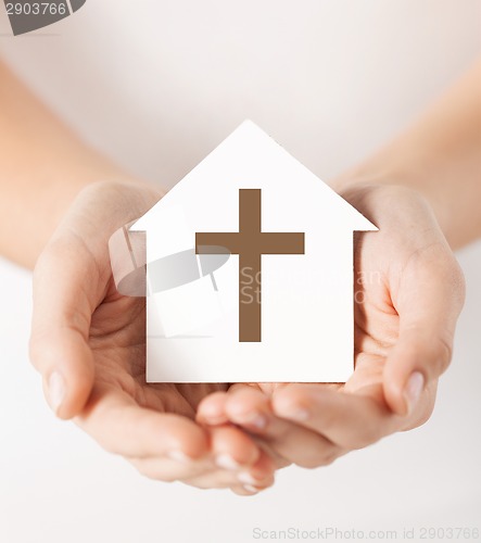 Image of hands holding paper house with cross symbol