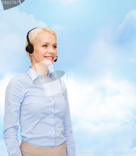 Image of friendly female helpline operator with headphones