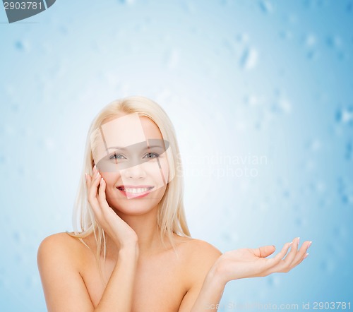 Image of smiling woman holding imaginary lotion jar