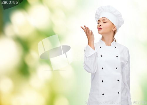 Image of smiling female chef showing delicious sign