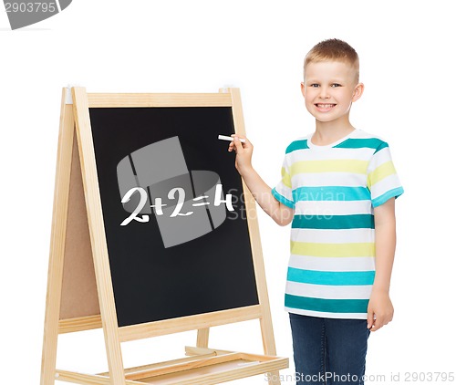 Image of smiling little boy with blank blackboard