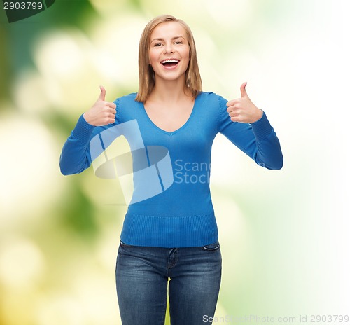 Image of smiling girl in casual clothes showing thumbs up