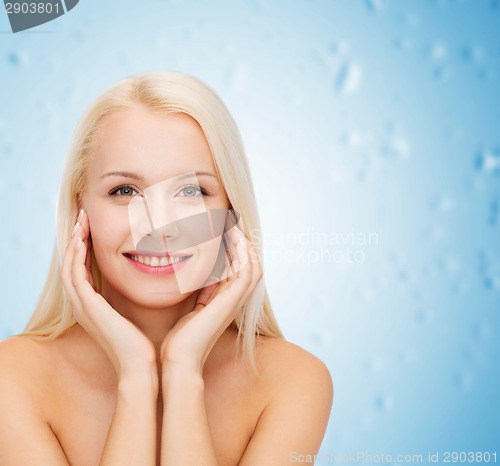 Image of beautiful woman touching her face skin