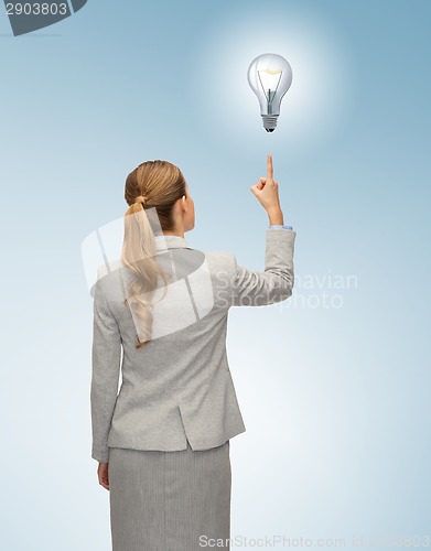 Image of businesswoman or teacher in suit from back