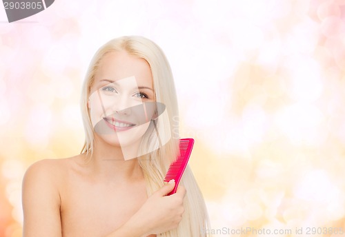 Image of smiling woman with hair brush