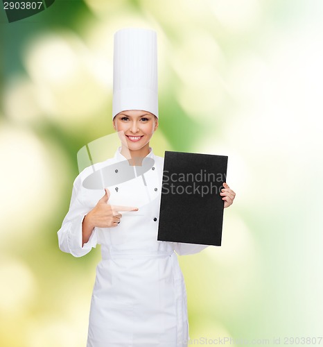 Image of smiling female chef with black blank paper