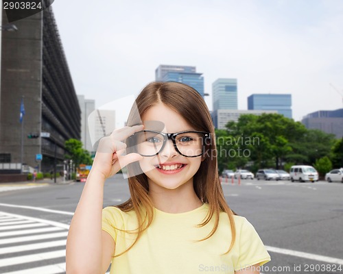 Image of smiling cute little girl in black eyeglasses