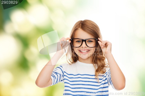 Image of smiling cute little girl with black eyeglasses