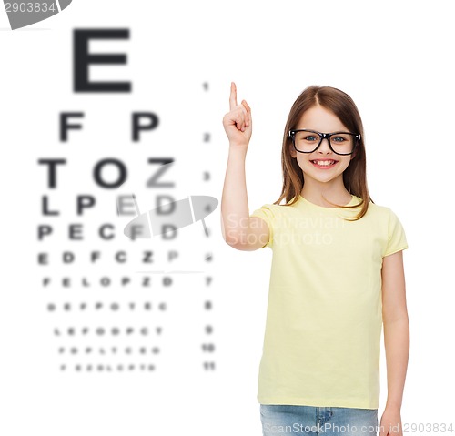 Image of smiling cute little girl in black eyeglasses