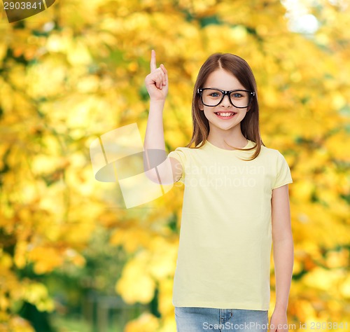 Image of smiling cute little girl in black eyeglasses