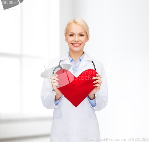 Image of smiling female doctor with heart and stethoscope