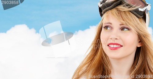 Image of smiling teenage girl in snowboard goggles