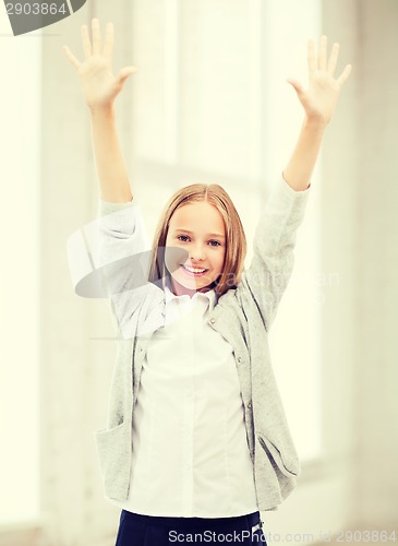 Image of student girl with hands up at school