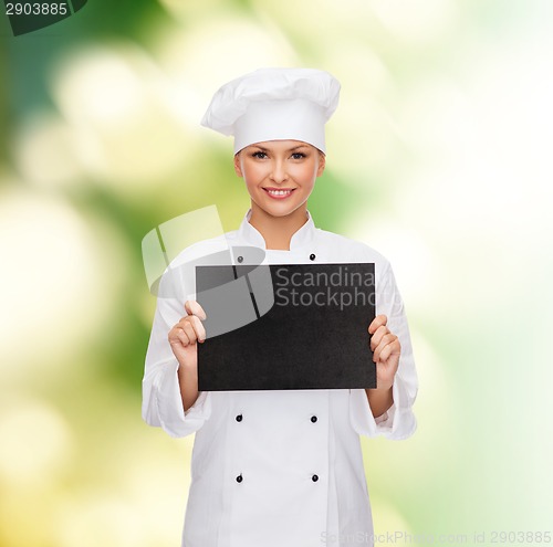 Image of smiling female chef with black blank paper