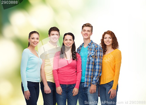 Image of group of smiling teenagers over green background