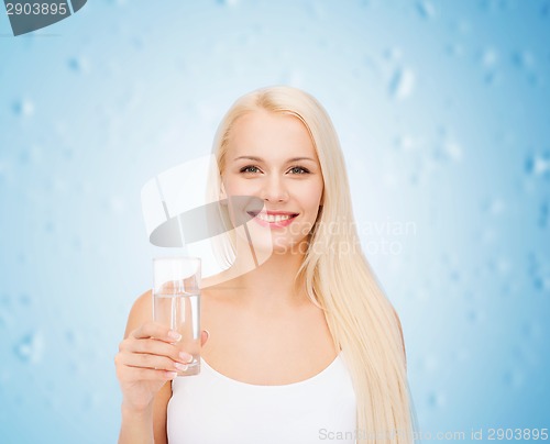 Image of young smiling woman with glass of water