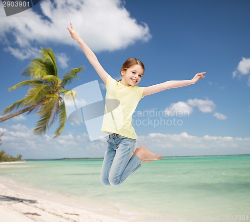 Image of smiling little girl jumping