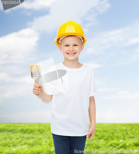 Image of smiling little boy in helmet with paint brush