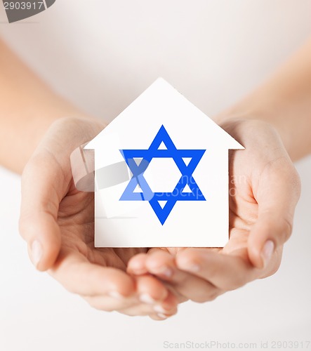 Image of hands holding house with star of david