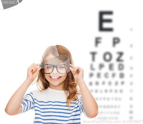 Image of smiling cute little girl with black eyeglasses