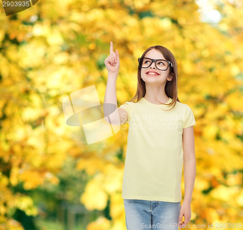 Image of smiling cute little girl in black eyeglasses