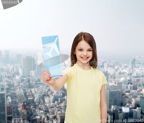 Image of smiling little girl with airplane ticket