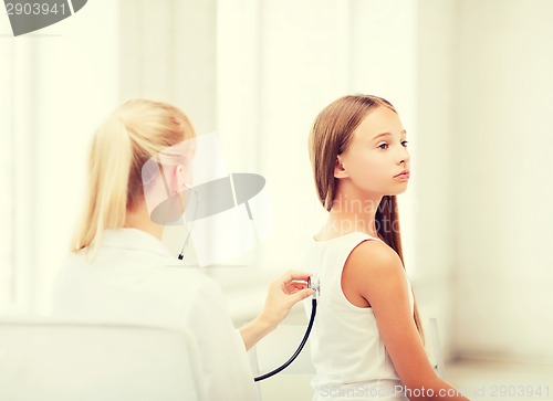 Image of doctor with stethoscope listening to the patient