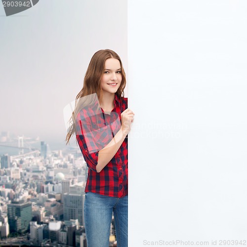 Image of smiling young teenage girl with white blank board