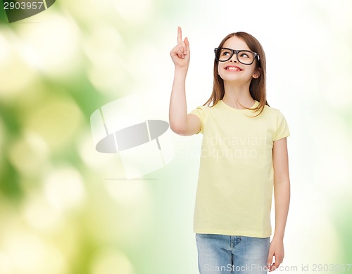 Image of smiling cute little girl in black eyeglasses