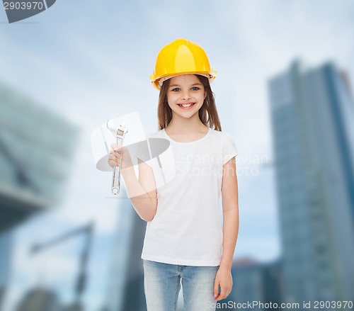Image of smiling little girl in hardhat with wrench
