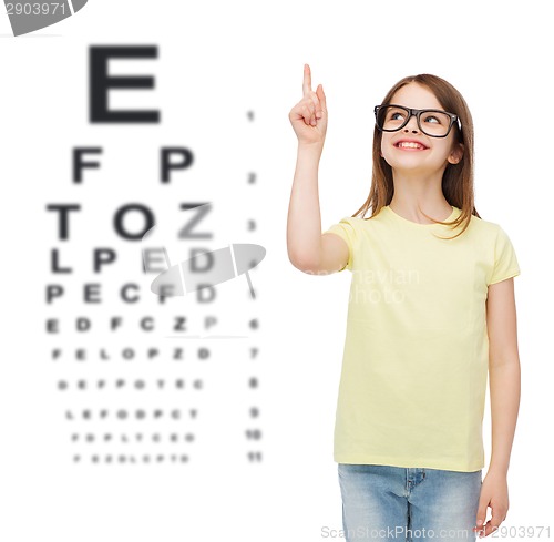 Image of smiling cute little girl in black eyeglasses