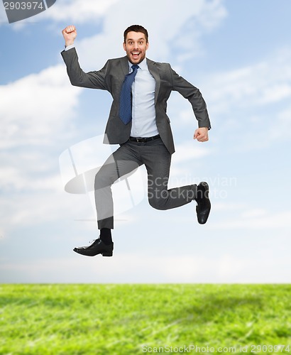 Image of smiling happy businessman jumping