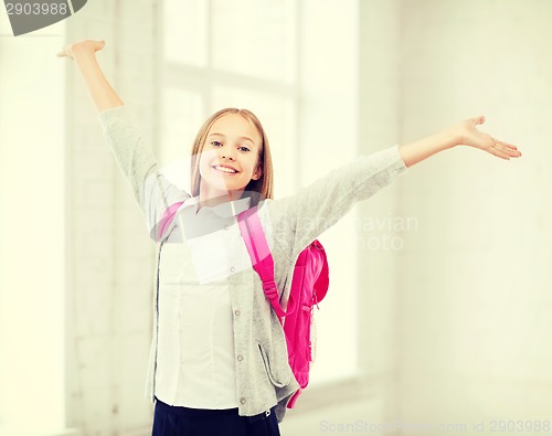 Image of student girl with hands up at school