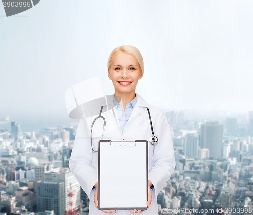 Image of smiling female doctor with clipboard