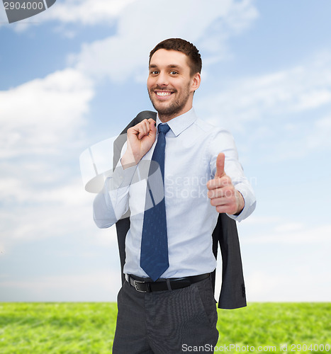 Image of smiling young businessman showing thumbs up