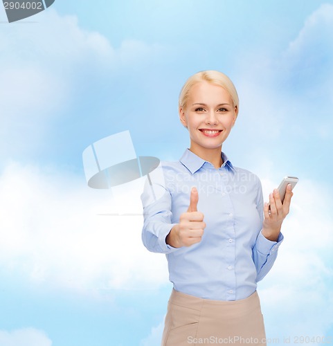 Image of young smiling businesswoman with smartphone