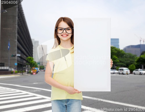 Image of little girl wearing eyeglasses with blank board