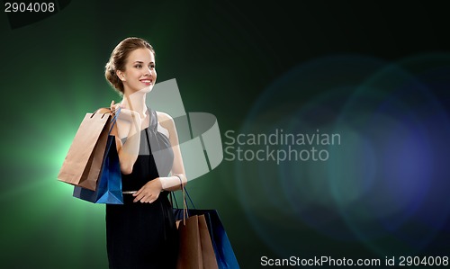 Image of smiling woman in dress with shopping bags